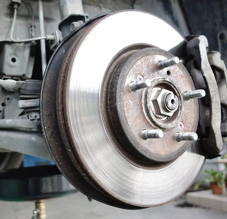 Brake Repair Technician Inspecting Brake System Technician inspecting brake components during a brake repair service at NorthState Auto Clinic.