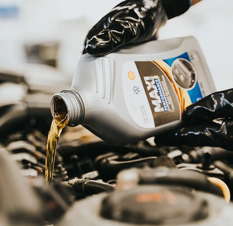 Coolant Service Adding Antifreeze Overflow Tank Antifreeze being added to a vehicle coolant overflow reservoir during fluid service.