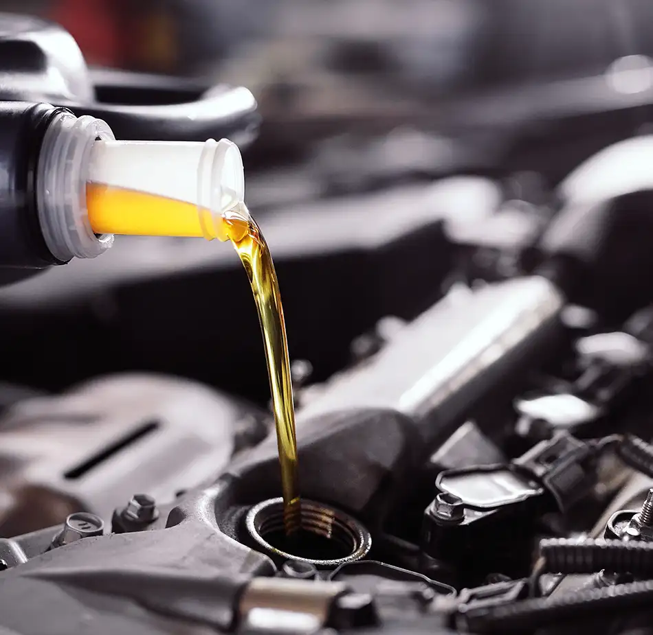 Oil Change Service Filling Engine Oil Fresh engine oil being added during a routine oil change service.